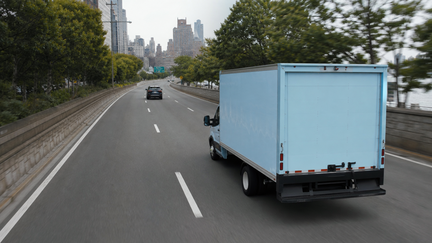Light-blue truck maintaining a safe following distance